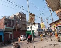 बिजली का खंबा सड़क के बीचोबीच झुका हुआ खड़ा है